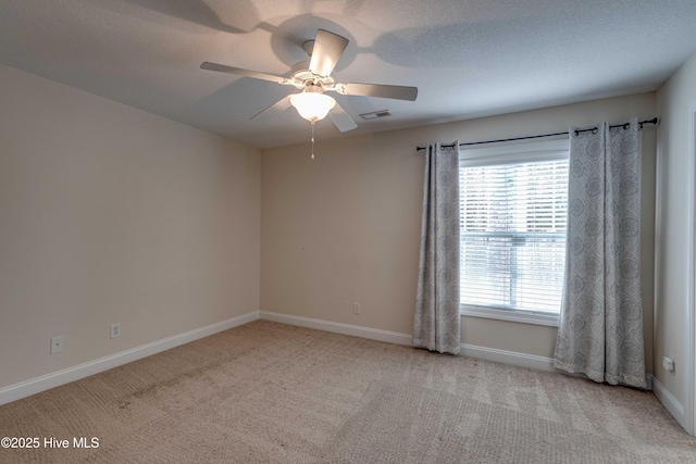 carpeted empty room featuring ceiling fan and a textured ceiling