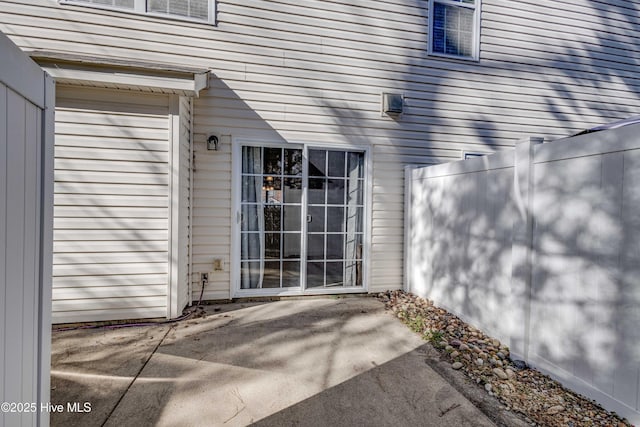 view of exterior entry featuring a patio