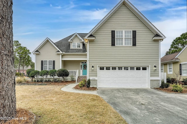 3566 Sanderling Dr SE, Southport, NC 28461 - traditional-style house featuring driveway, an attached garage, a front lawn, and roof with shingles