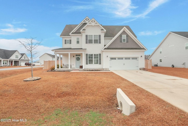 craftsman-style home with a porch, a garage, and a front yard