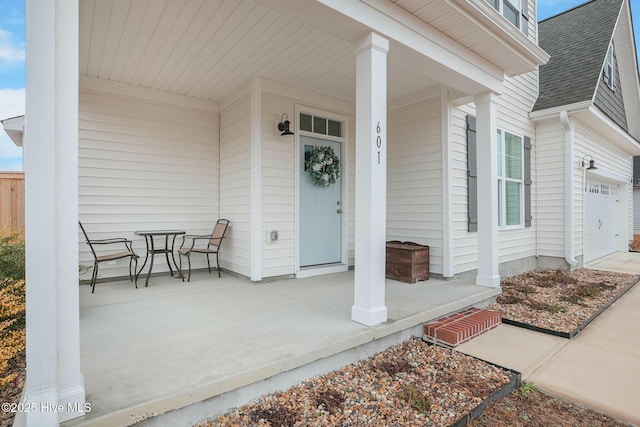 property entrance with a garage and covered porch