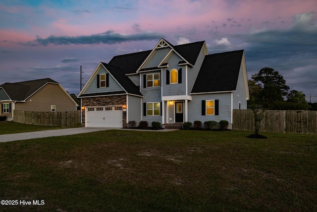 view of front of home featuring roof with shingles, a front lawn, stone siding, concrete driveway, and fence
