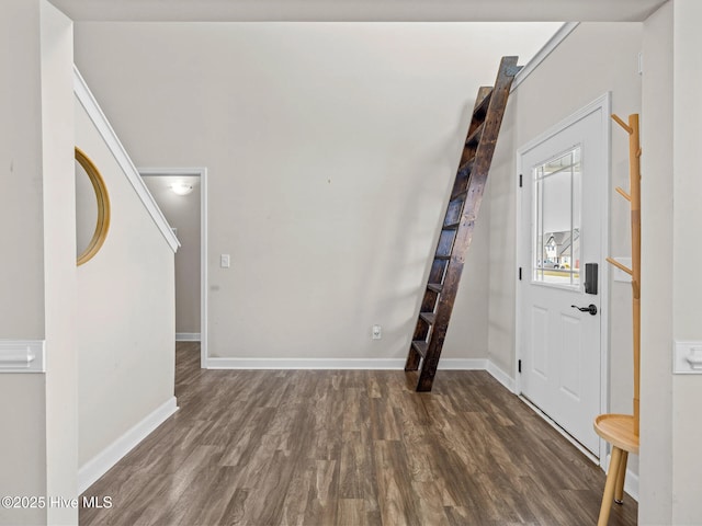 foyer featuring stairway, baseboards, and wood finished floors