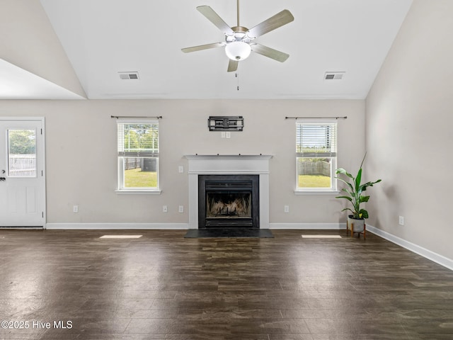 unfurnished living room featuring lofted ceiling, visible vents, a wealth of natural light, and wood finished floors