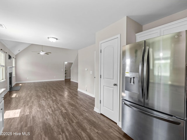 kitchen with lofted ceiling, stainless steel fridge with ice dispenser, a ceiling fan, dark wood-style flooring, and white cabinetry