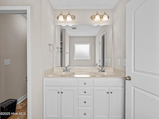 full bath with double vanity, visible vents, and a sink