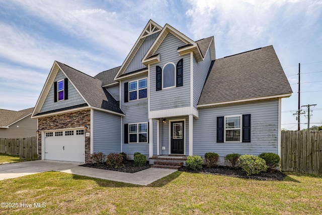 view of front of house with concrete driveway, fence, roof with shingles, and a front yard