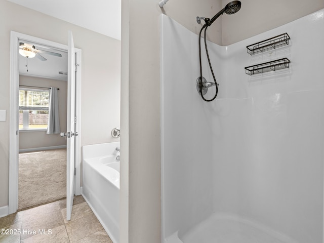 bathroom featuring ceiling fan, a garden tub, walk in shower, and baseboards