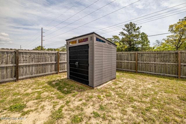 view of shed with a fenced backyard