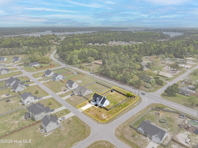 drone / aerial view featuring a residential view and a forest view