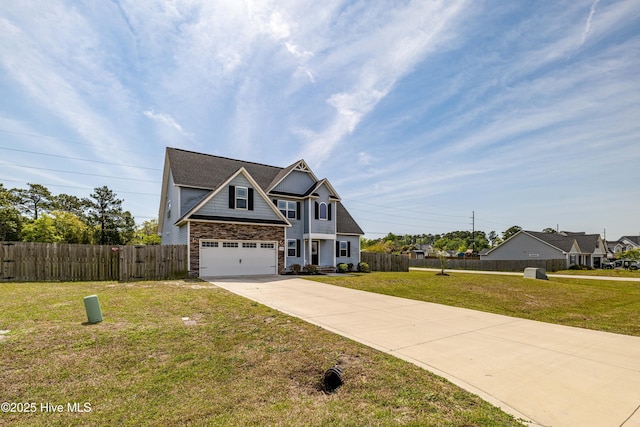 craftsman house featuring a garage, a front lawn, concrete driveway, and fence