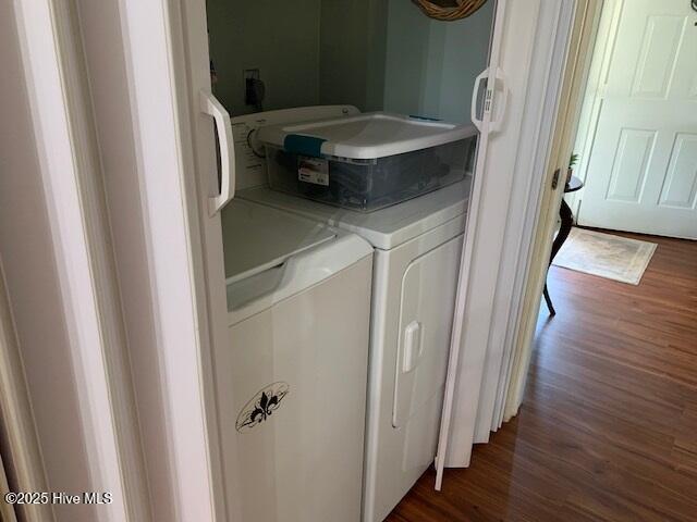 laundry room featuring dark hardwood / wood-style flooring and separate washer and dryer