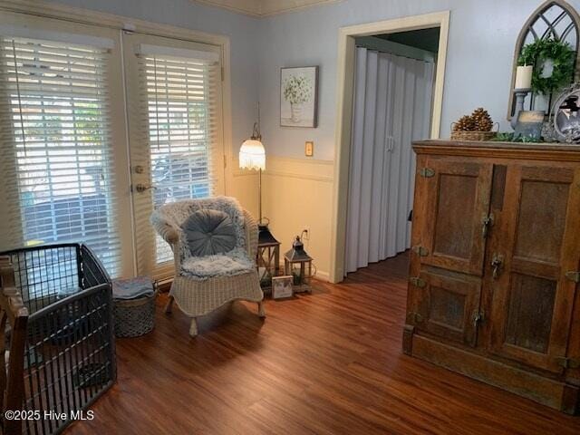 living area with dark hardwood / wood-style floors and french doors