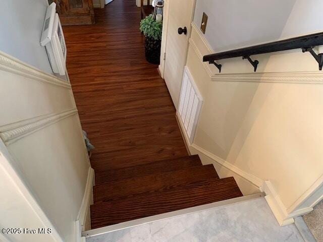 stairway with hardwood / wood-style flooring