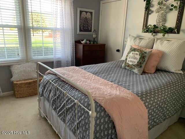 bedroom featuring light colored carpet