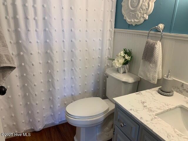 bathroom with vanity, hardwood / wood-style flooring, and toilet