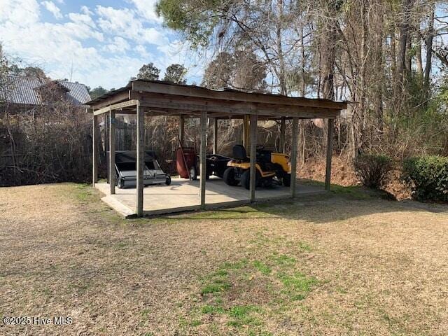 view of car parking with a yard and a carport