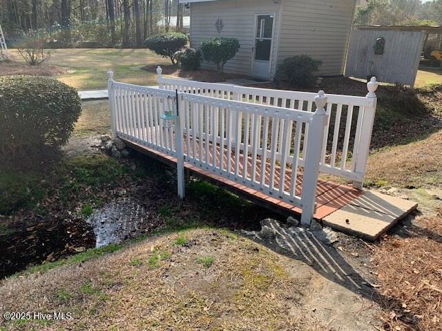 wooden deck featuring a storage shed