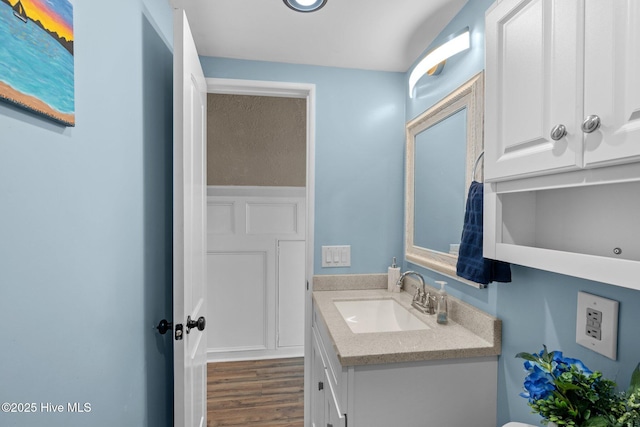 bathroom with wood finished floors and vanity