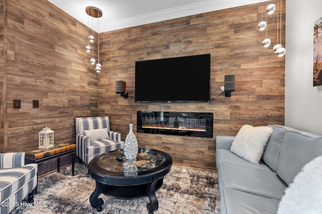 living room featuring a glass covered fireplace and crown molding