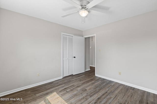 spare room with a ceiling fan, baseboards, and wood finished floors