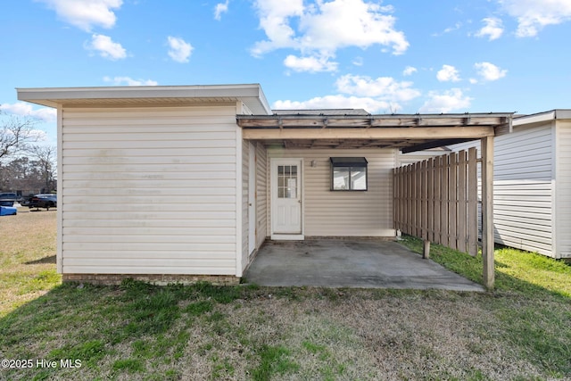 exterior space with a carport and fence