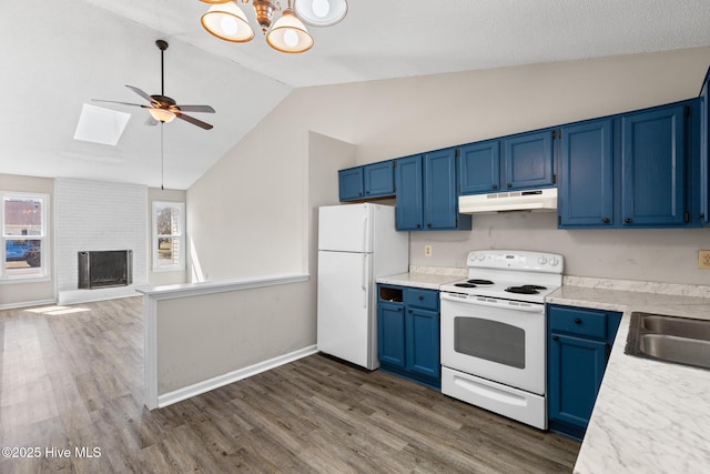 kitchen featuring white appliances, blue cabinetry, a fireplace, light countertops, and under cabinet range hood