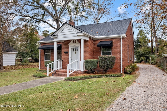 bungalow-style home with a front yard