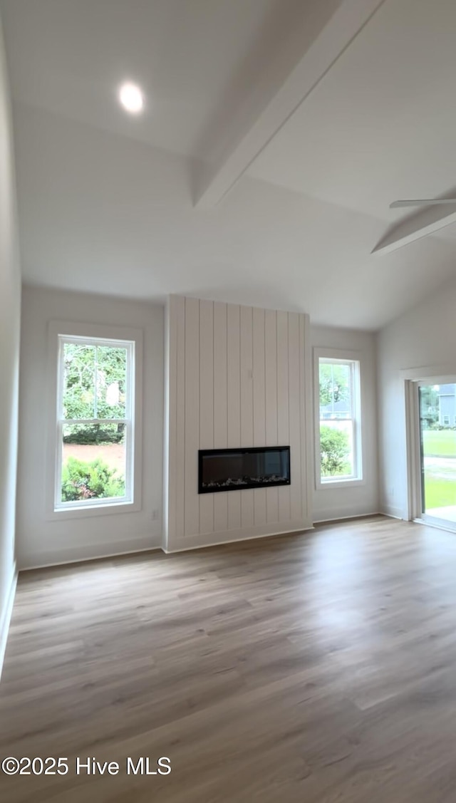 1643 Deerfield Dr SW, Ocean Isle Beach, NC 28469 - unfurnished living room with wood finished floors, a large fireplace, and ceiling fan