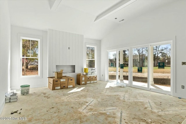 unfurnished sunroom with vaulted ceiling with beams