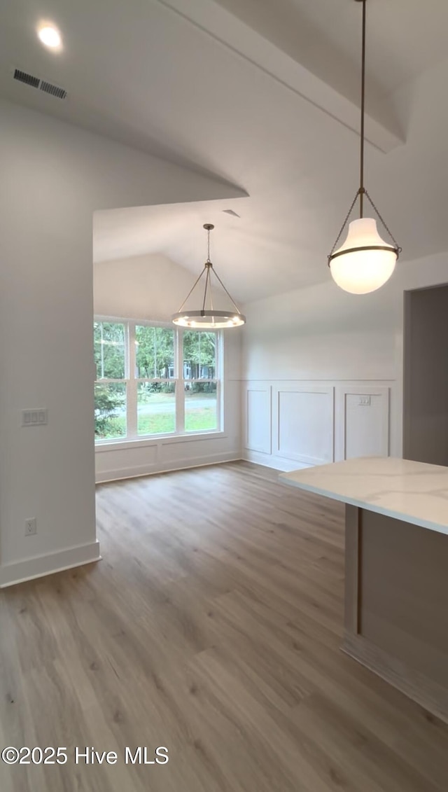 1643 Deerfield Dr SW, Ocean Isle Beach, NC 28469 - unfurnished dining area featuring wood finished floors and lofted ceiling