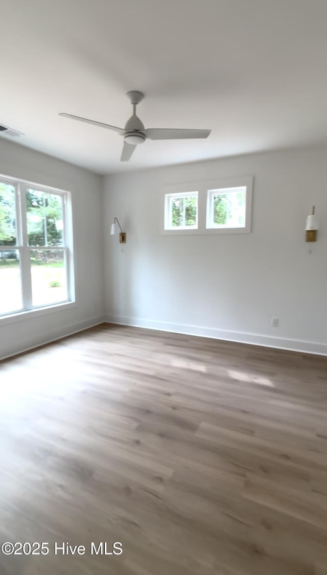 1643 Deerfield Dr SW, Ocean Isle Beach, NC 28469 - spare room with plenty of natural light, wood finished floors, and a ceiling fan
