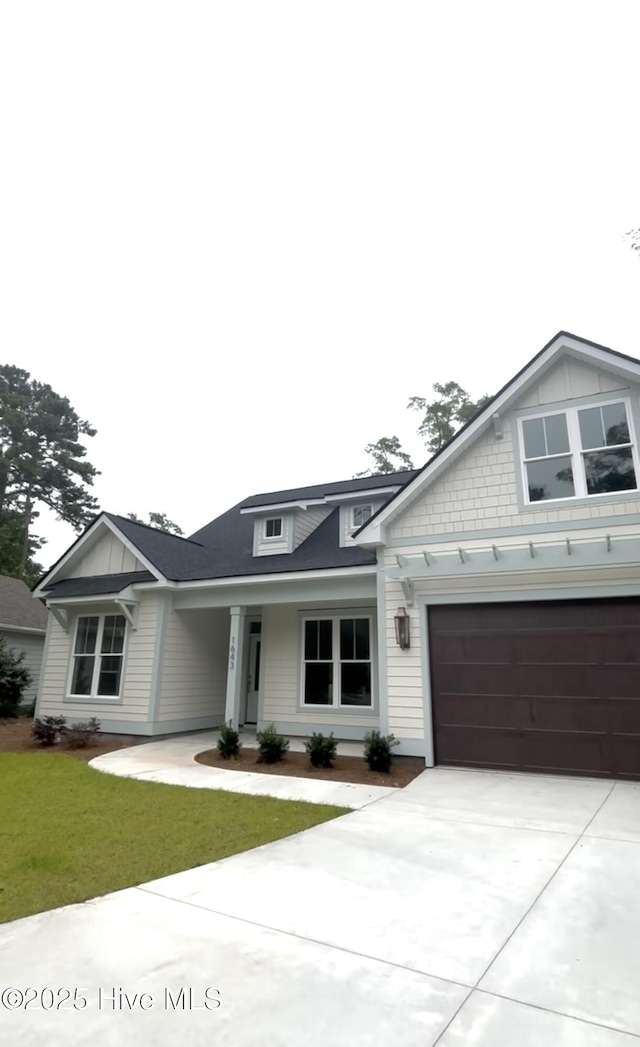 1643 Deerfield Dr SW, Ocean Isle Beach, NC 28469 - view of front facade featuring concrete driveway and a front yard