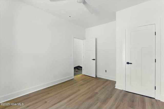 1643 Deerfield Dr SW, Ocean Isle Beach, NC 28469 - unfurnished bedroom with wood finished floors and a ceiling fan