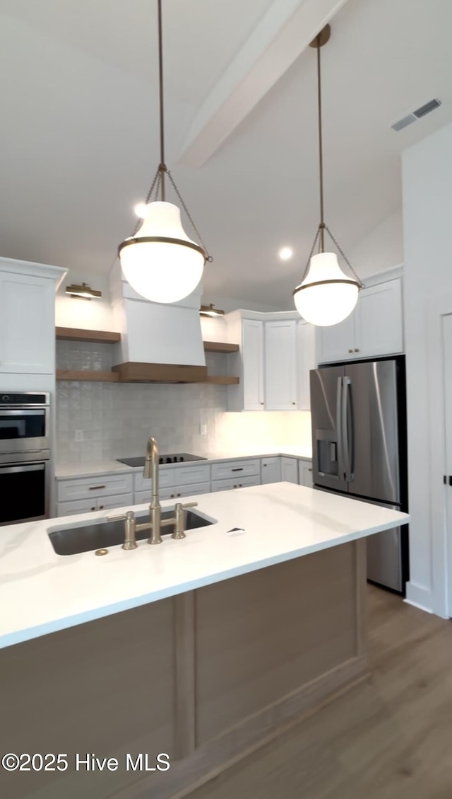 1643 Deerfield Dr SW, Ocean Isle Beach, NC 28469 - kitchen with open shelves, appliances with stainless steel finishes, decorative backsplash, and hanging light fixtures