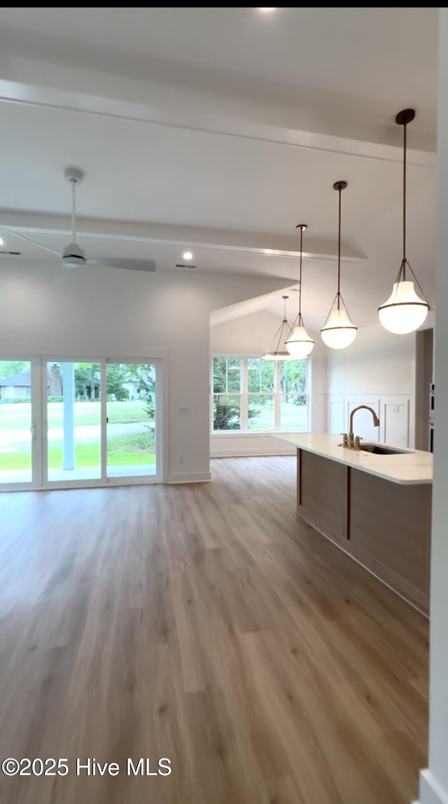 1643 Deerfield Dr SW, Ocean Isle Beach, NC 28469 - kitchen with beam ceiling, open floor plan, light wood-style floors, ceiling fan, and recessed lighting