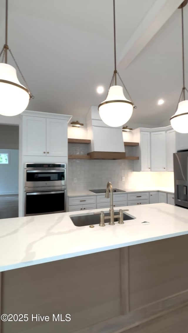 1643 Deerfield Dr SW, Ocean Isle Beach, NC 28469 - kitchen with open shelves, appliances with stainless steel finishes, wall chimney range hood, decorative backsplash, and pendant lighting