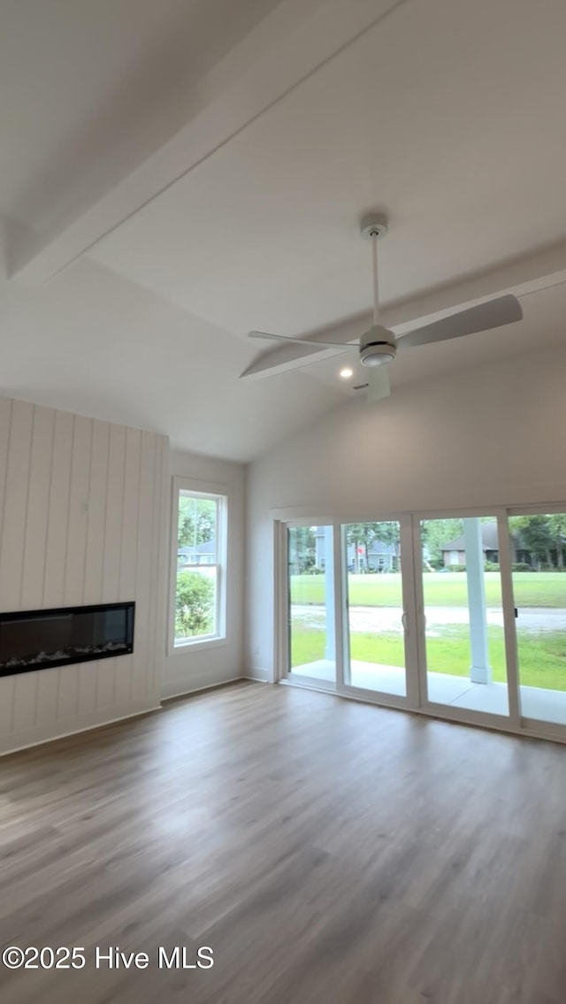 1643 Deerfield Dr SW, Ocean Isle Beach, NC 28469 - unfurnished living room featuring a ceiling fan, lofted ceiling, wood finished floors, and a large fireplace