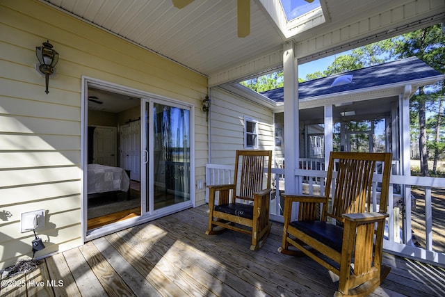 wooden terrace featuring a ceiling fan