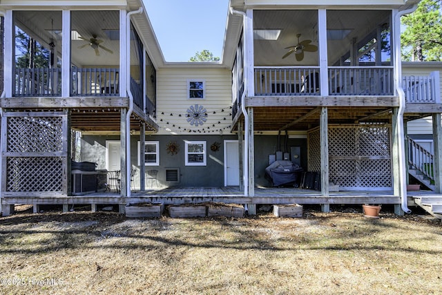 rear view of house featuring a sunroom, ceiling fan, and central AC unit