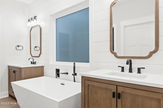 1773 Oakbrook Dr SW, Ocean Isle Beach, NC 28469 - full bathroom featuring a freestanding tub, two vanities, and a sink