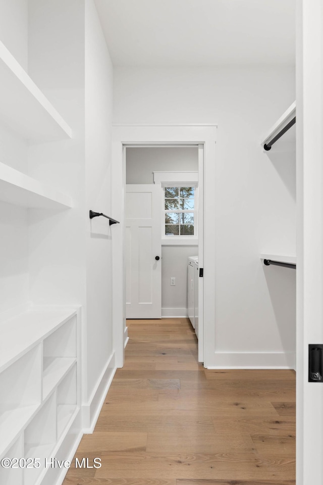 1773 Oakbrook Dr SW, Ocean Isle Beach, NC 28469 - walk in closet with washer and dryer and light wood-style flooring