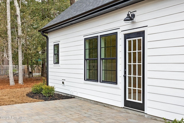 1773 Oakbrook Dr SW, Ocean Isle Beach, NC 28469 - exterior space with a patio, fence, and a shingled roof