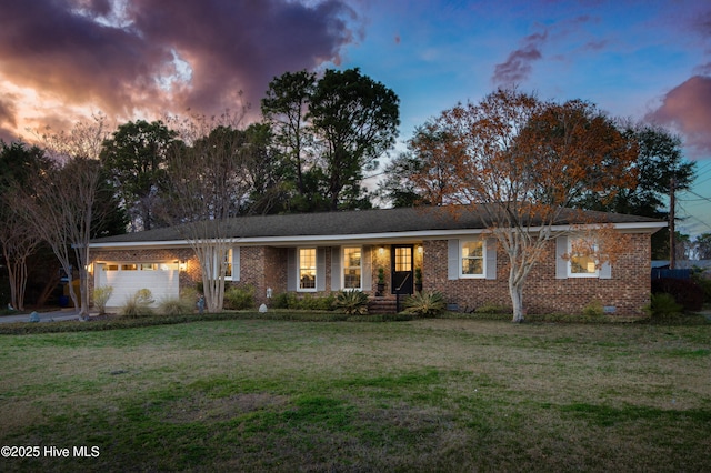 single story home with crawl space, brick siding, an attached garage, and a front yard