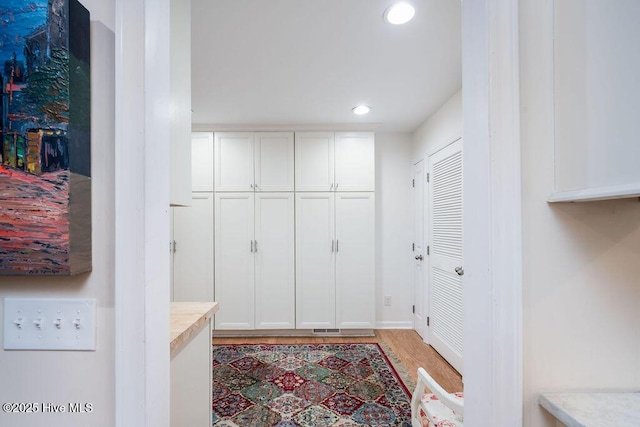 mudroom with recessed lighting, visible vents, and wood finished floors