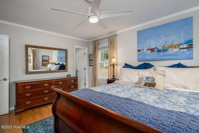 bedroom with ornamental molding, light wood-style floors, and a ceiling fan