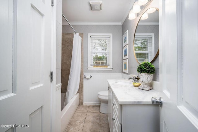 bathroom with toilet, ornamental molding, tile walls, and vanity