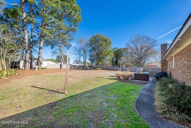 view of yard with a fenced backyard and an outdoor living space