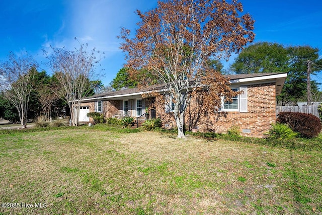 single story home featuring crawl space, an attached garage, a front yard, and brick siding