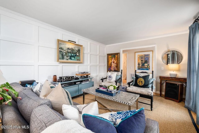 living area with crown molding and a decorative wall